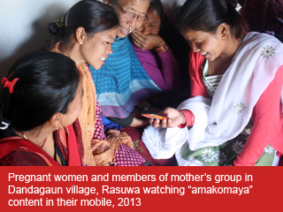Pregnant women and members of a mothers’ group in Dandagaun, Rasuwa, watching content on a phone