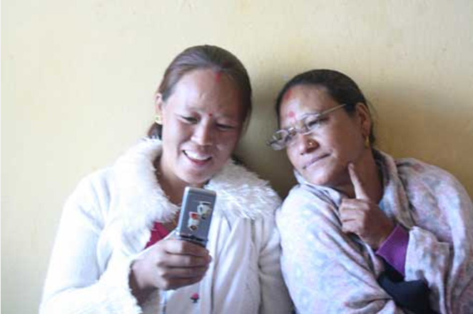 Two women looking together at pregnancy content on a mobile phone