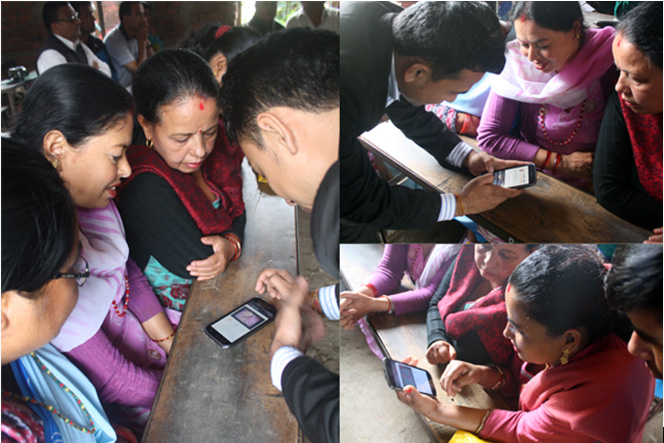 Women and a field worker looking at pregnancy content on a mobile phone together