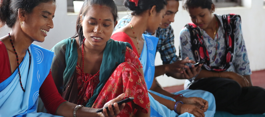 Female Community Health Volunteers in Chitwan using mobile phones together